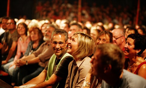 Audience watching a show in a small theatre